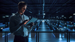 Successful Data Center IT Specialist Using Tablet Computer. Serv